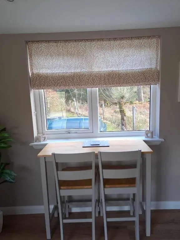 a window with a table and two chairs in front of it at Rowan Bank Retreat in Fort Augustus