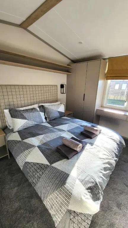a bedroom with a large bed with pillows on it at 95 Grantown in Grantown on Spey