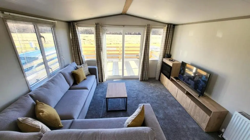 a living room with a couch and a tv at 95 Grantown in Grantown on Spey