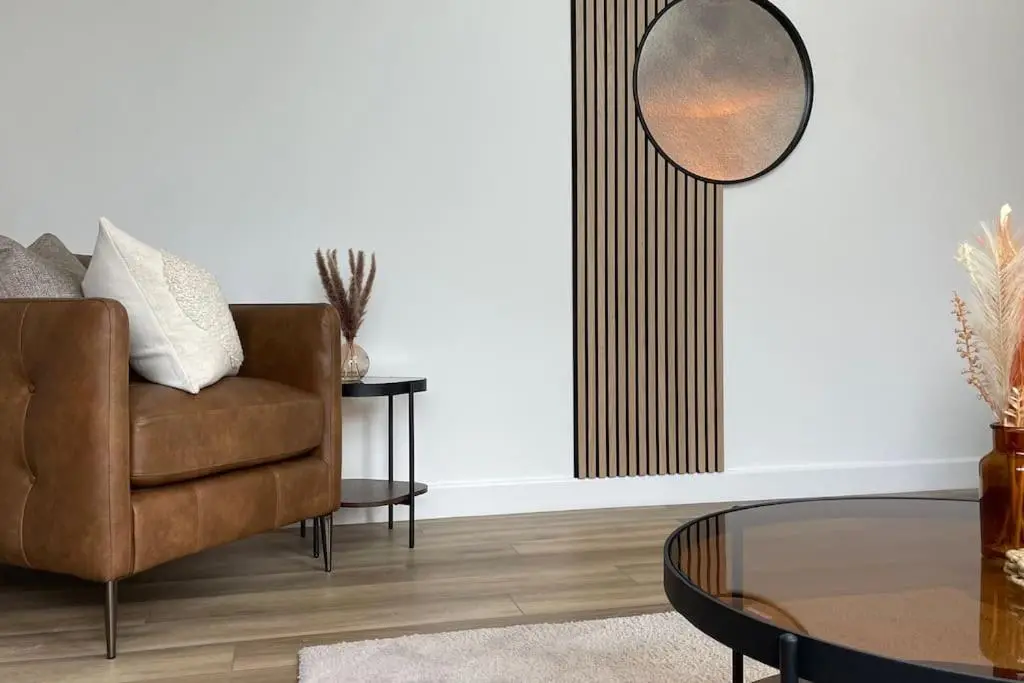 a living room with a chair and a table at Braeview - by Caithness Luxury Apartments NC500 - 3 Bedroom Luxury holiday home - Sleeps Work teams upto 3 & holiday makers upto 5 in Wick