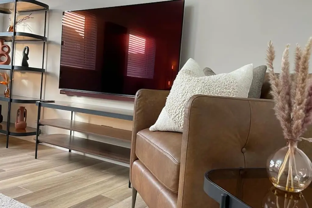 a living room with a couch and a tv at Braeview - by Caithness Luxury Apartments NC500 - 3 Bedroom Luxury holiday home - Sleeps Work teams upto 3 & holiday makers upto 5 in Wick