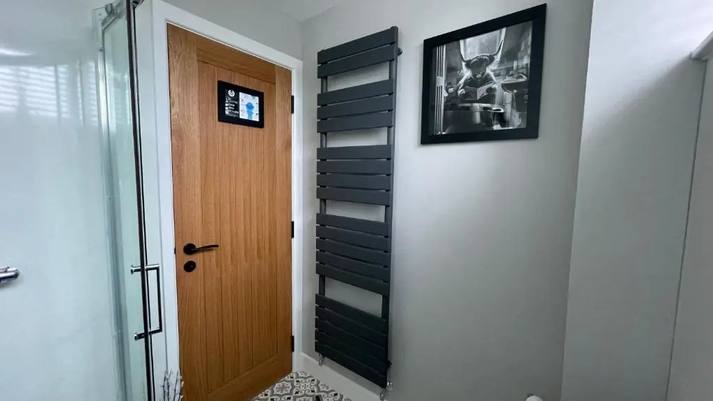 a hallway with a door and a picture on a wall at Braeview - by Caithness Luxury Apartments NC500 - 3 Bedroom Luxury holiday home - Sleeps Work teams upto 3 & holiday makers upto 5 in Wick