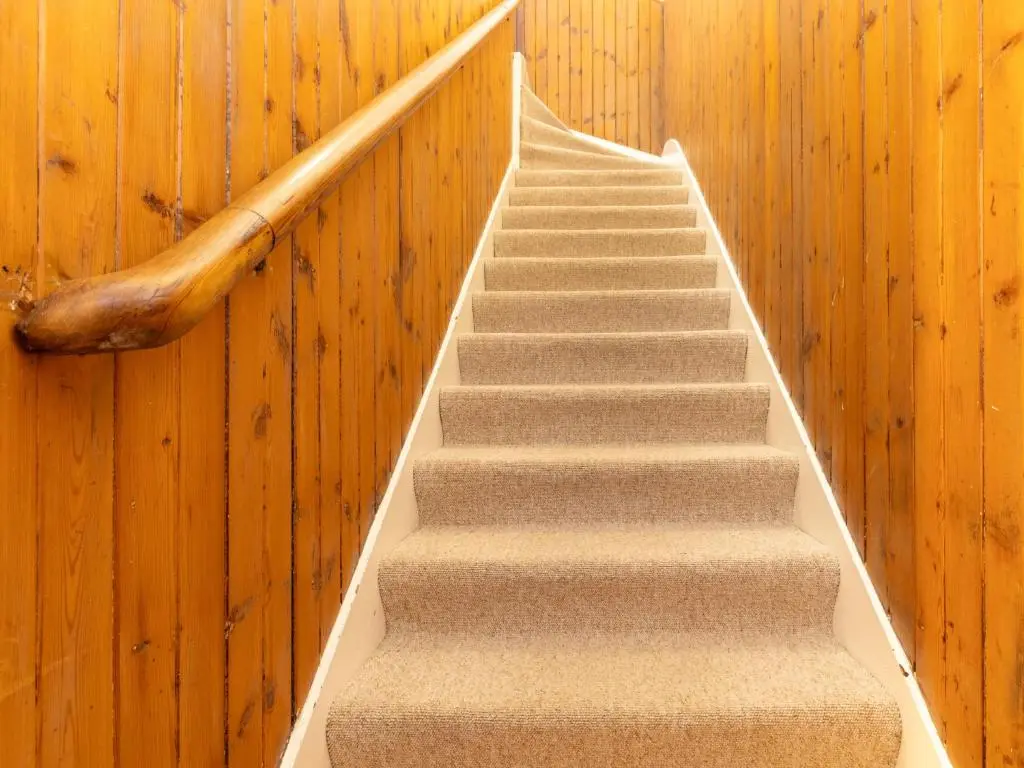 a stair case in a building with a rail at Holiday Home Railway House by Interhome in Aviemore