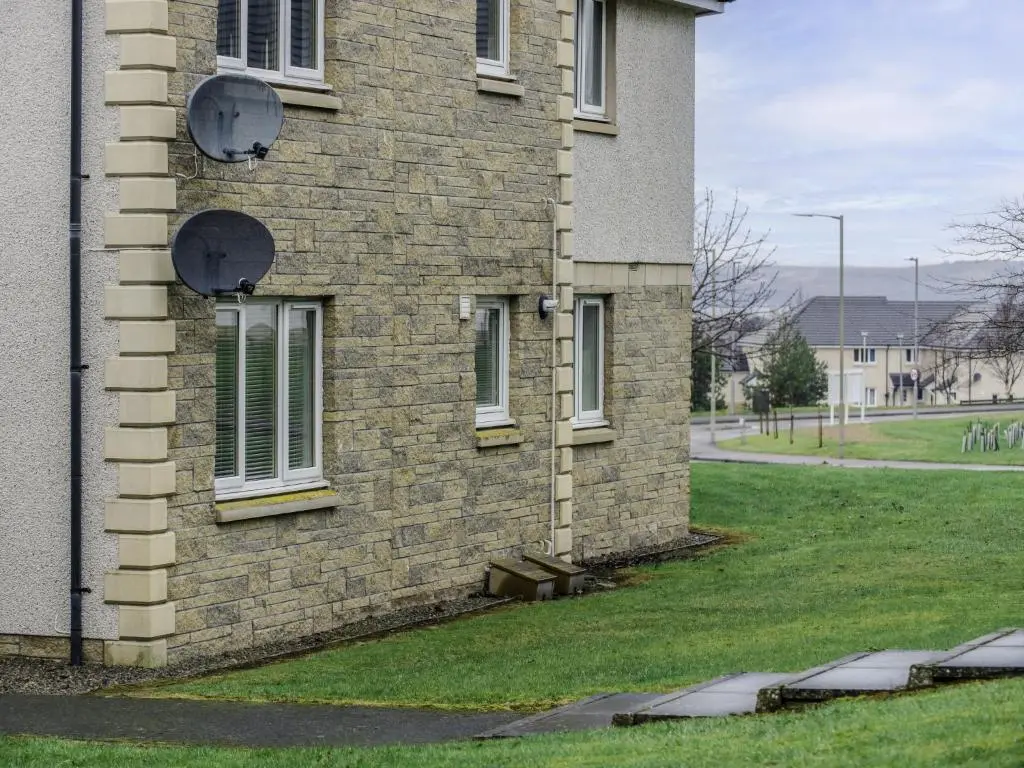 a brick building with windows on the side of it at Apartment Number 39 by Interhome in Inverness