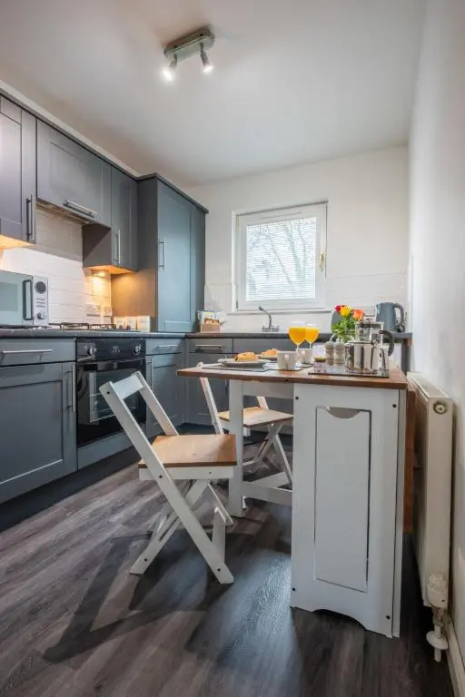 a kitchen with a table and a chair in it at Apartment Number 39 by Interhome in Inverness