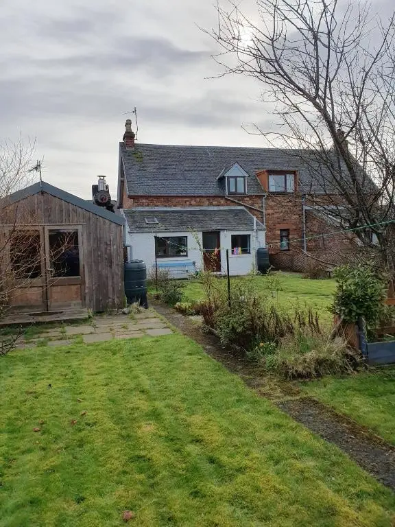 a house with a yard in front of it at Crossing Cottage, Brora in Brora