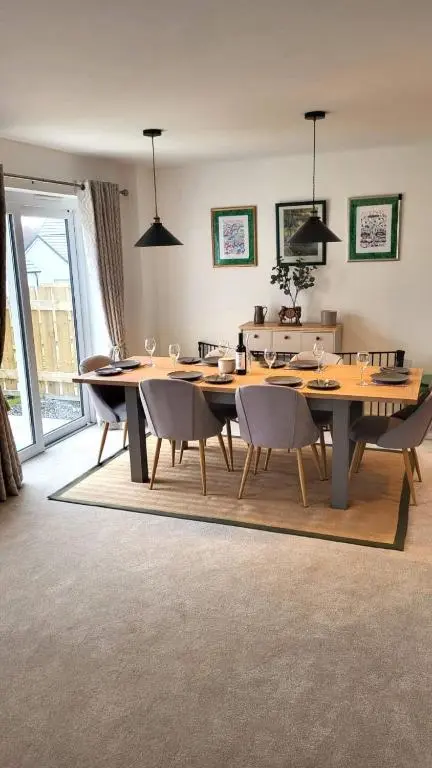 a dining room with a large wooden table and chairs at Insch House in Kincraig