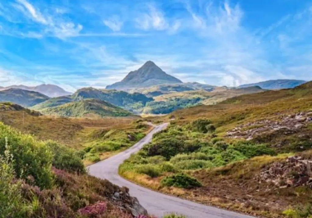 a road in the mountains with a mountain in the background at The Retreat Hotel in Strathpeffer