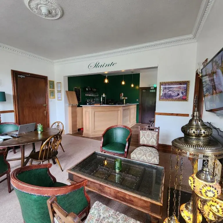 a living room with a table and chairs and a table sidx sidx sidx at The Retreat Hotel in Strathpeffer