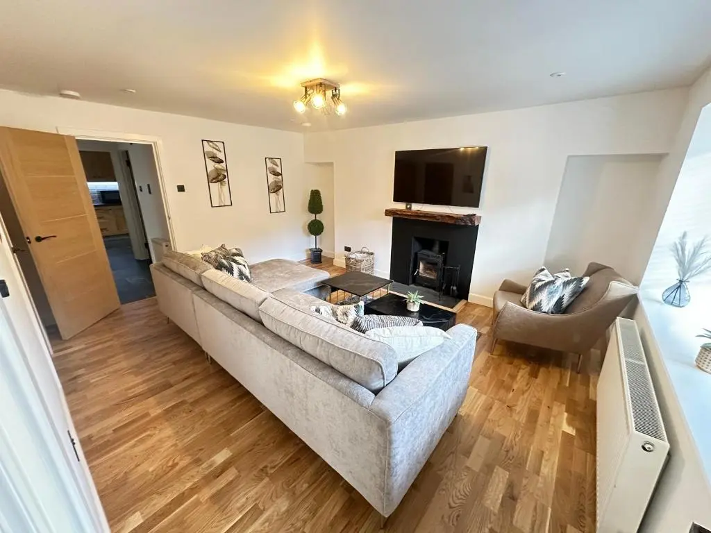 a living room with a couch and a tv at Smiddy Cottage Bauds in Buckie