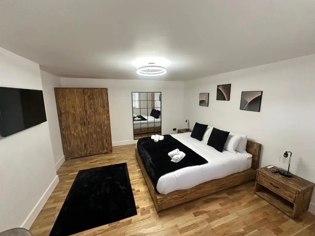 a bedroom with a large bed in a room at Smiddy Cottage Bauds in Buckie