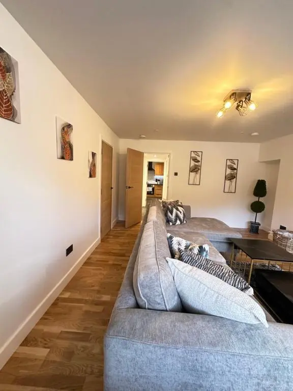 a living room with a couch and a table at Smiddy Cottage Bauds in Buckie