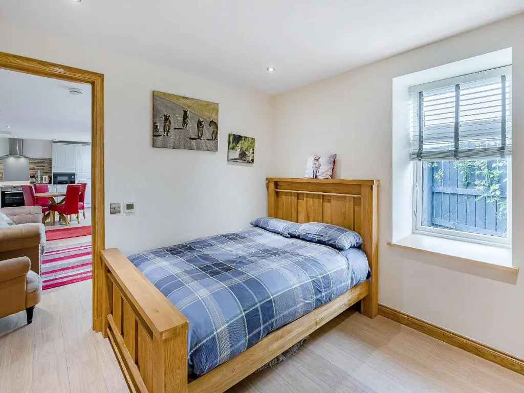 a bedroom with a bed and a window at Mains Of Durn Cottage, in Banff