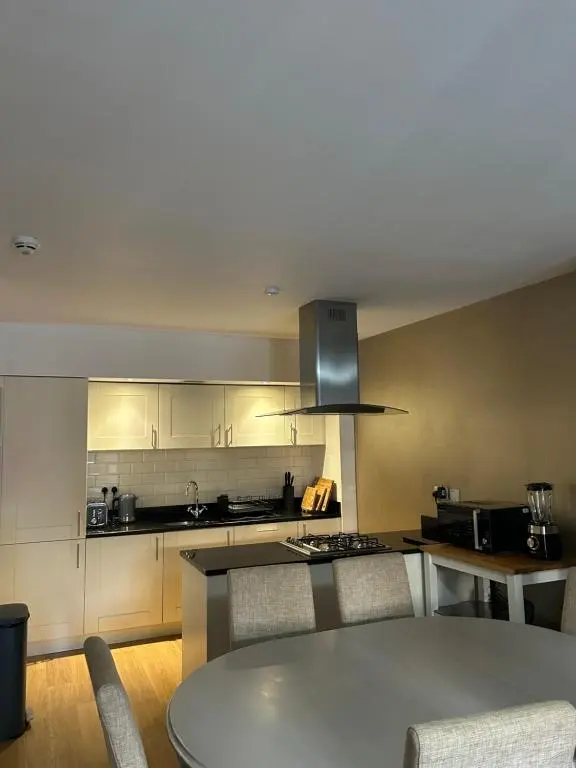 a kitchen with a table and a counter top at Abbey Church 9 The Nave 2 bedroom Luxury Self catering apartment in Historic Abbey in Fort Augustus