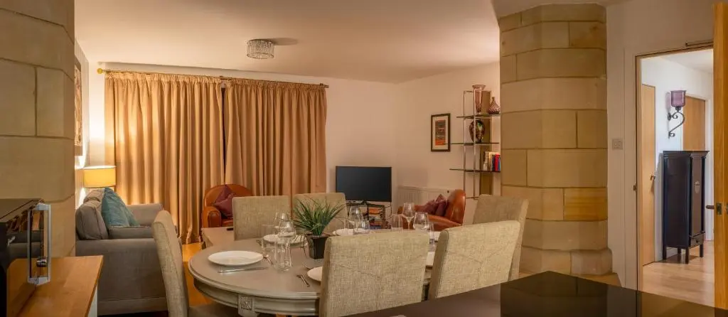 a dining room and living room with a table and chairs at Abbey Church 9 The Nave 2 bedroom Luxury Self catering apartment in Historic Abbey in Fort Augustus