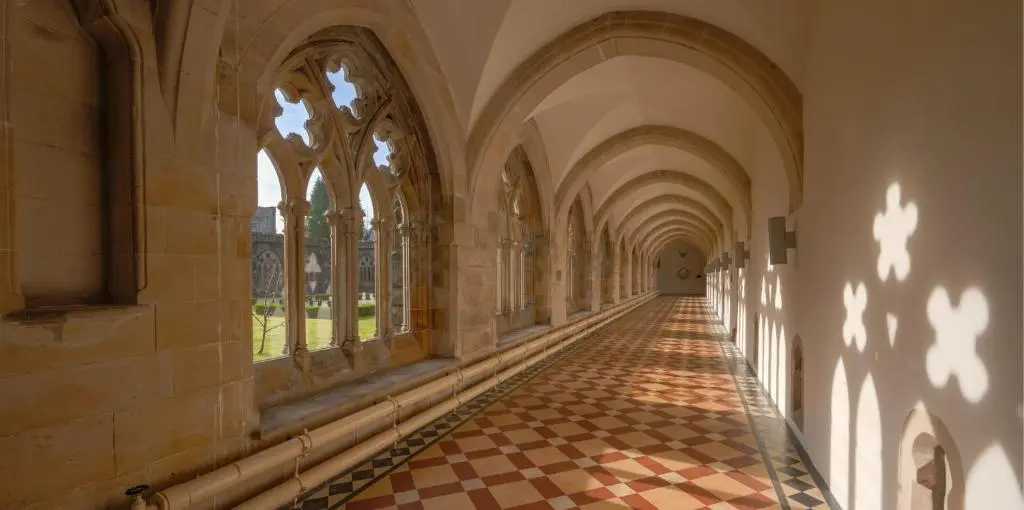 an empty hallway of a building with windows and a checkered floor at AC19 Lower North Aisle - Luxury Self Catering 2 Bedroom Apartment in Fort Augustus
