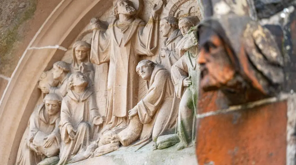 a wall with a carving of people on it at AC19 Lower North Aisle - Luxury Self Catering 2 Bedroom Apartment in Fort Augustus