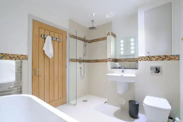 a bathroom with a toilet and a sink and a shower at Beautiful Lodge with hot tub & panoramic views in Boat of Garten