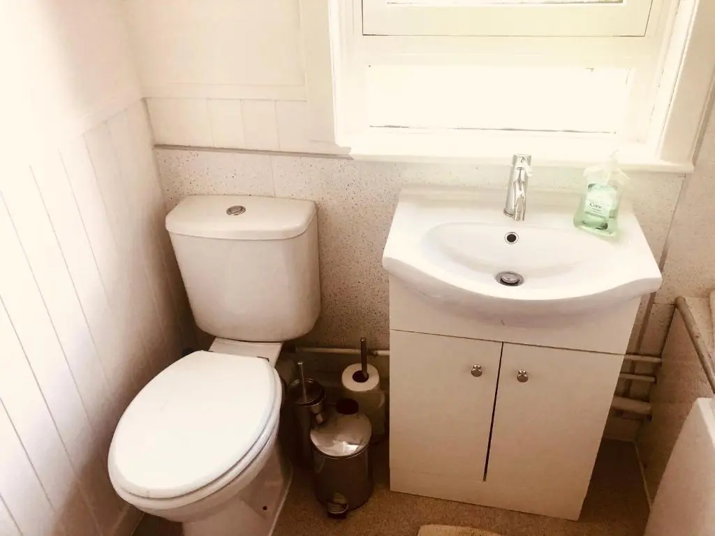 a small bathroom with a toilet and a sink at Inverthorn House in Inverness