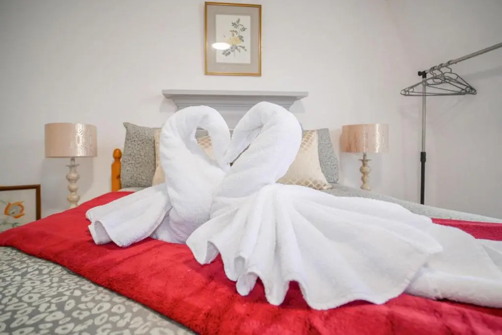 a bed with white towels on top of it at Telford Rd 5 Bedroom House Inverness in Inverness