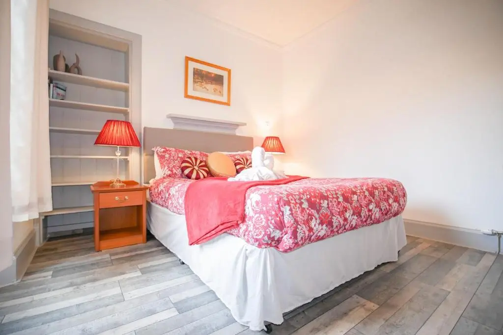 a bedroom with a bed and a table with lamps at Telford Rd 5 Bedroom House Inverness in Inverness