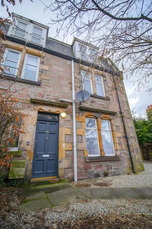a brick house with a blue door and windows at Telford Rd 5 Bedroom House Inverness in Inverness