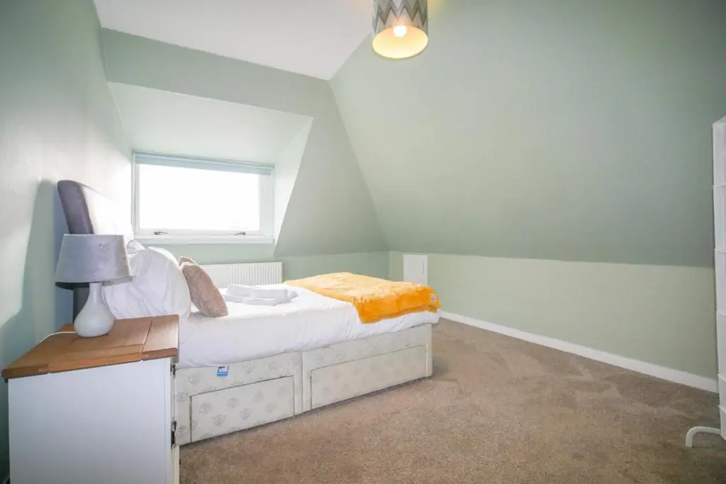 a small bedroom with a bed and a window at Telford St 4 Bedroom House Inverness in Inverness