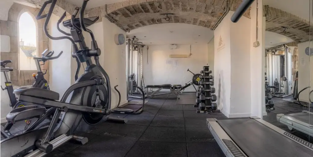 a gym with treadmills and exercise bikes in it at Major's Apartment 3 Bedroom Self Catering Property in historic Abbey in Fort Augustus