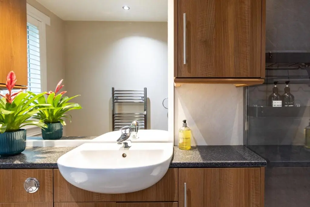 a bathroom with a white sink in a kitchen at Apartment 91 in Inverness