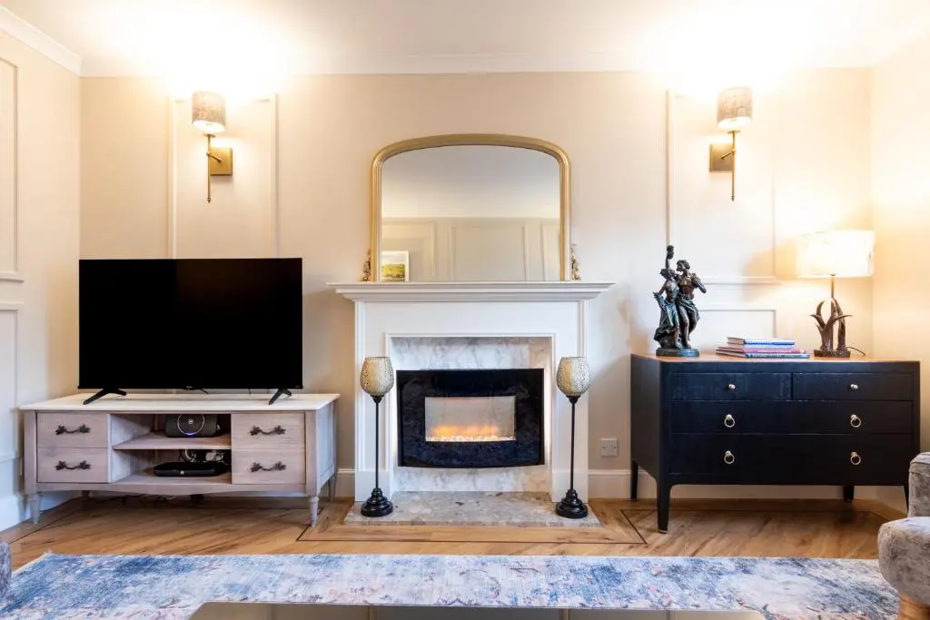 a living room with a tv and a fireplace at Apartment 91 in Inverness