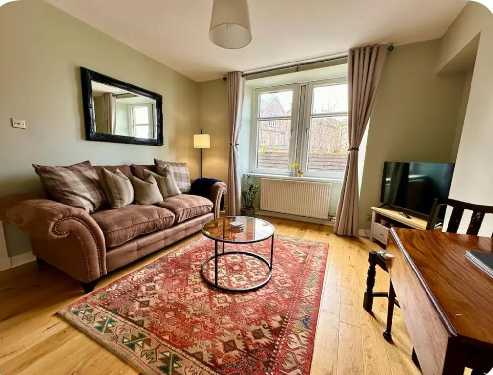 a living room with a couch and a table at Bed on the Brae in Inverness
