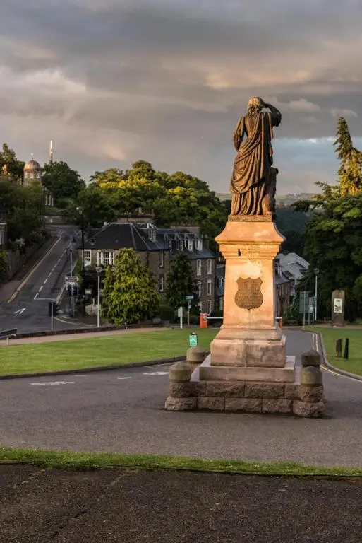 a statue of a woman standing on a street at Bed on the Brae in Inverness