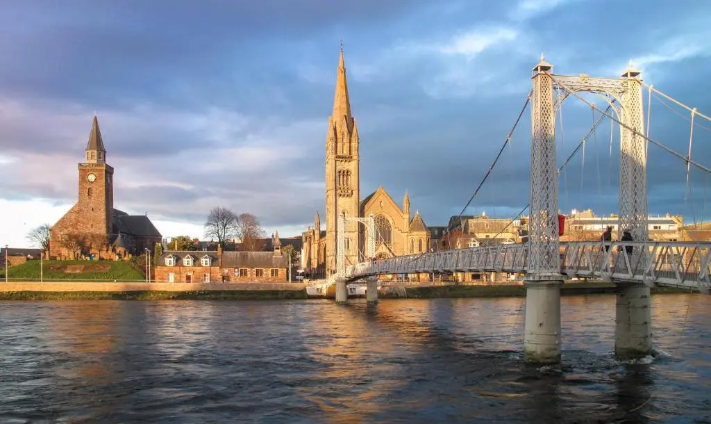 a bridge over a river in front of a city at Bed on the Brae in Inverness