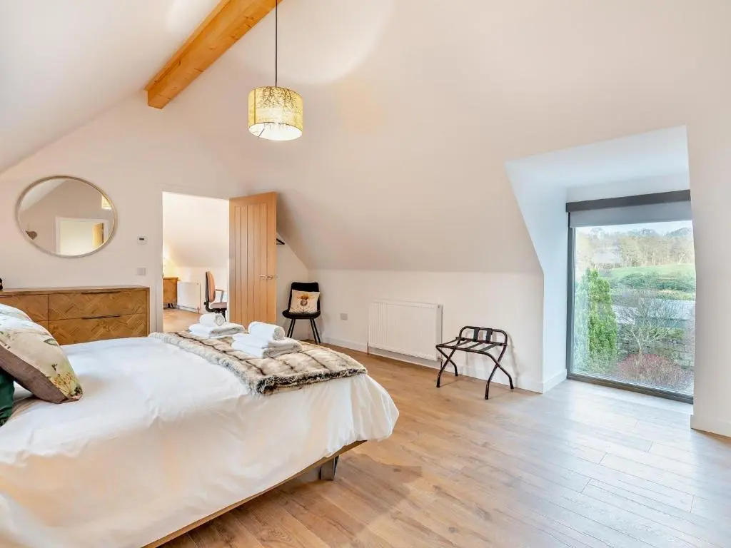 a bedroom with a large bed and a large window at 4 Bed in Dyce 93914 in Dyce