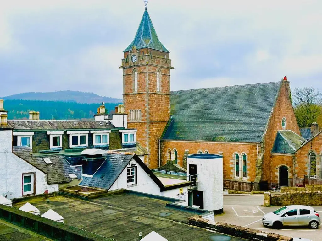 a large brick building with a clock tower at Entire flat in Banchory, Aberdeenshire, Scotland in Banchory