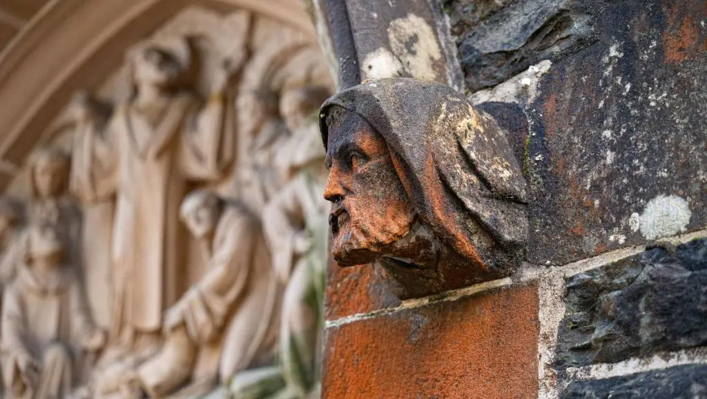 a statue of a head on the side of a building at The Caledonian 3 Bedroom Self Catering Apartment in historic Abbey in Fort Augustus