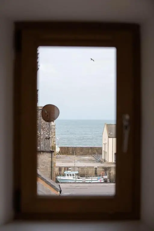 a view of the ocean from a window at Apartment Harbour Nights Deluxe 7C by Interhome in Lossiemouth