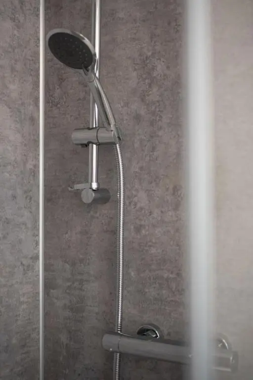 a shower with a shower head in a bathroom at Apartment Harbour Nights Deluxe Number 12 by Interhome in Lossiemouth