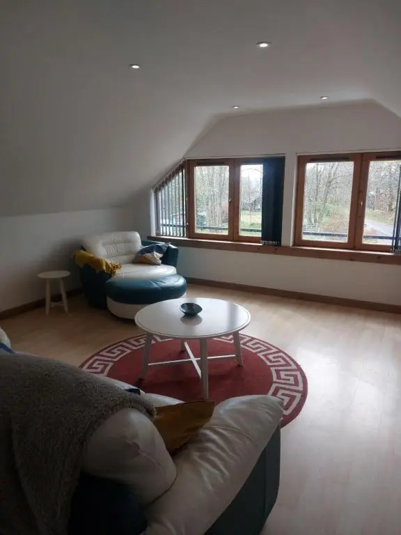 a living room with a couch and a table at Kiledinmuir in Tore