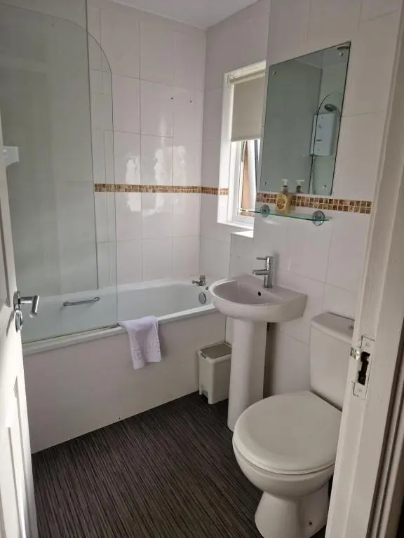 a bathroom with a sink and a tub and a toilet at No 70G in Inverness