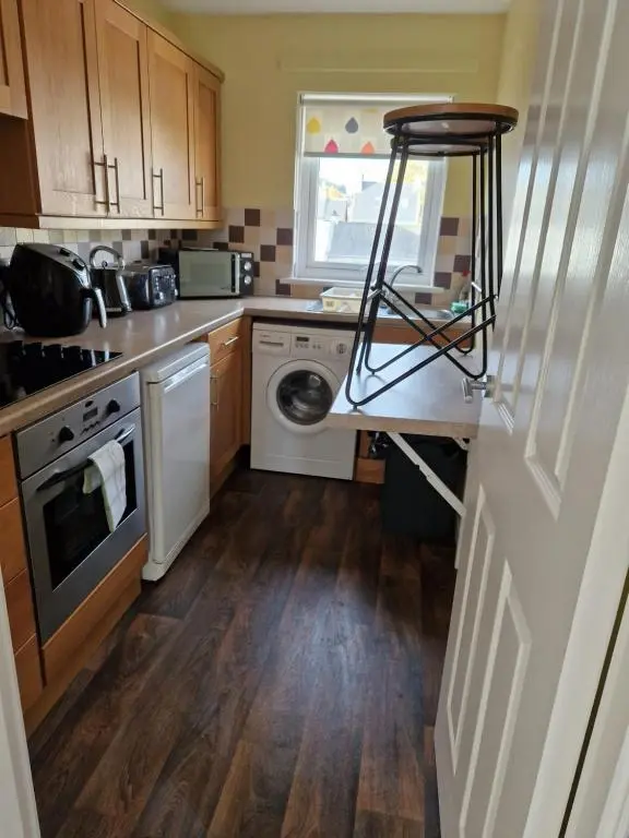 a kitchen with a sink and a dishwasher at No 70G in Inverness