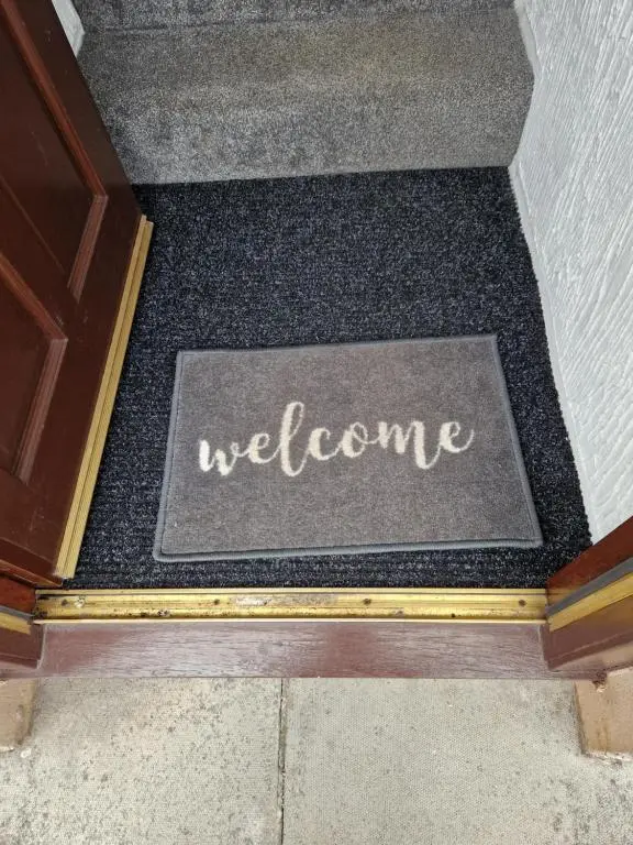 a welcome sign on the floor of a stairway at No 70G in Inverness