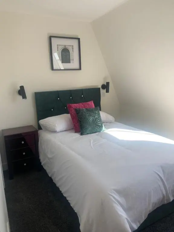 a bedroom with a white bed with two pillows on it at STAG & THISTLE HOTEL AND RESTAURANT in Fraserburgh