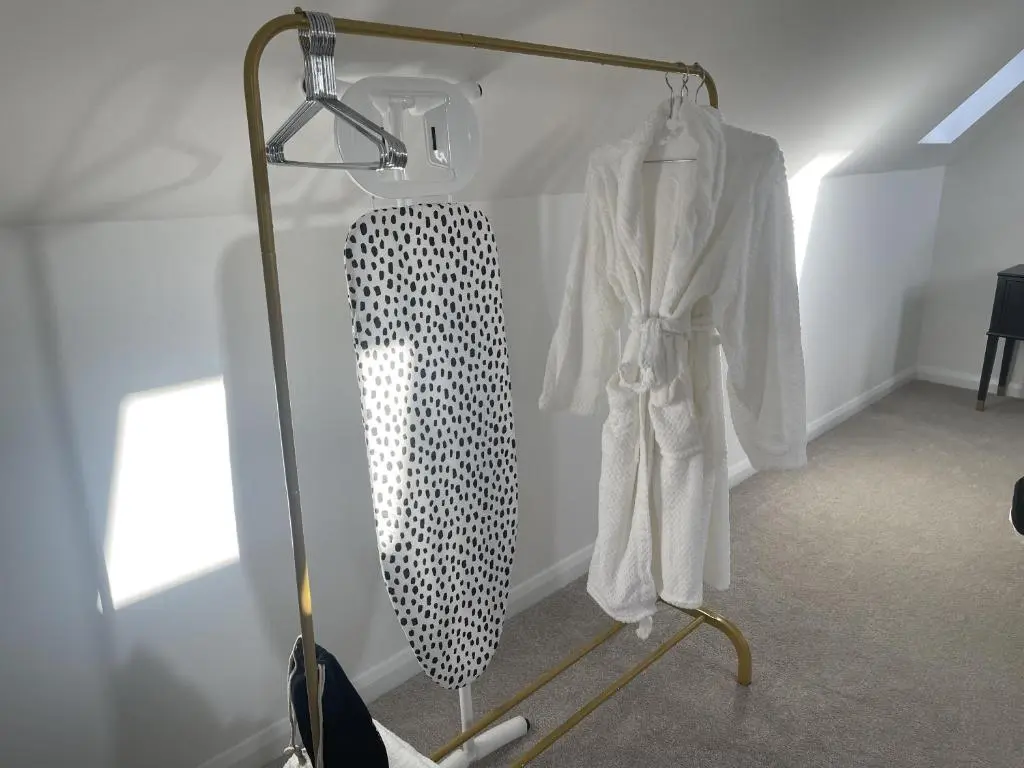a room with a rack with white robes and a mirror at 4 Guests - Inverness Highland Hideaway Nc500 in Inverness