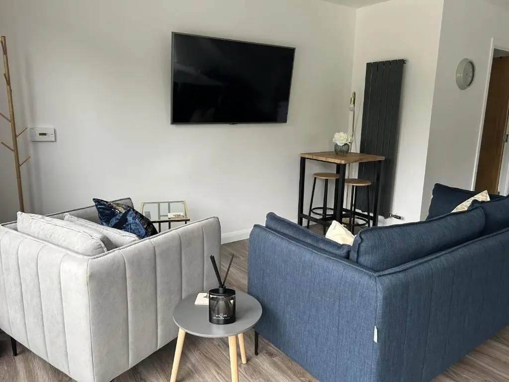 a living room with two blue chairs and a tv at 4 Guests - Inverness Highland Hideaway Nc500 in Inverness