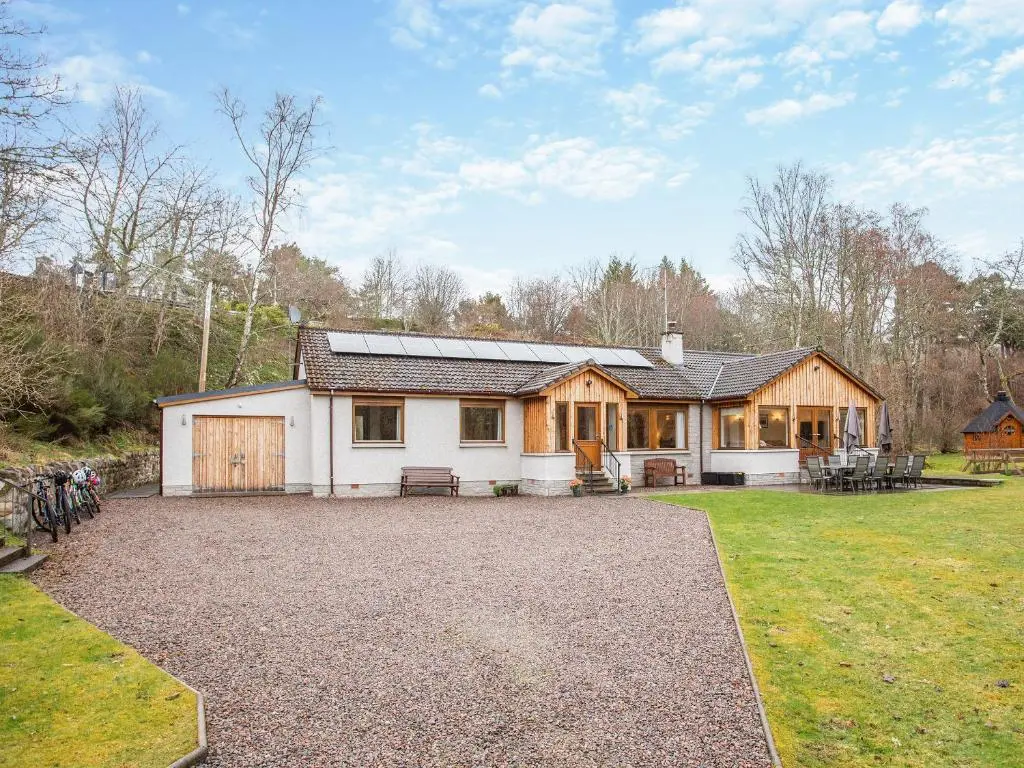 a house with a large driveway in front of it at Balnagowan Mill in Nethy Bridge