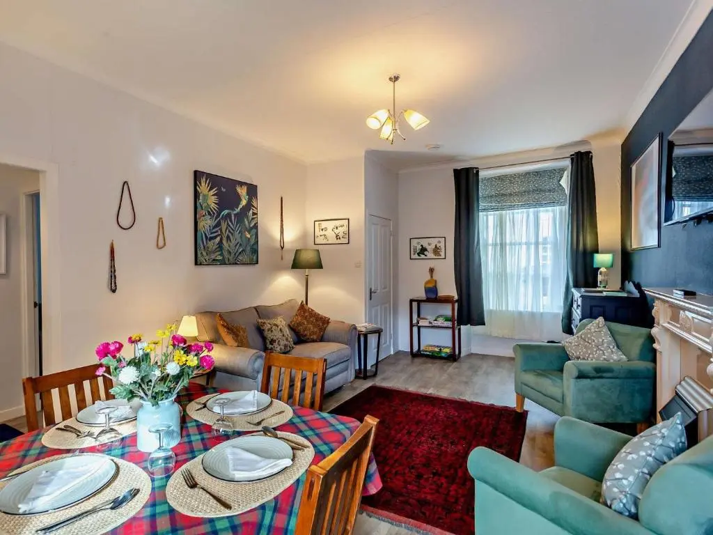 a living room with a table and a couch at 1 Bed in Cullen 94536 in Cullen