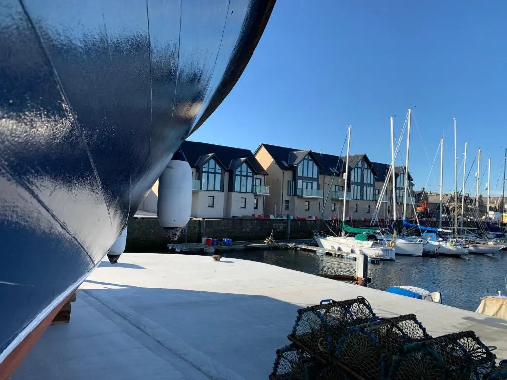 a boat docked at a marina with boats in the water at Spinnaker in Lossiemouth