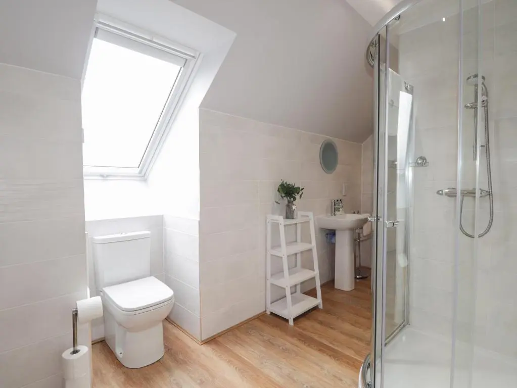 a bathroom with a shower and a toilet and a sink at Spinnaker in Lossiemouth