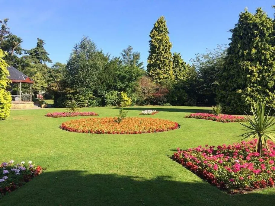 a garden with many flowers in the grass at Heather House, beautiful family home, sleeps 8 in Inverness